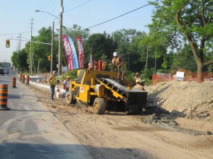 Loader working during a road reconstruction with traffic cones in place