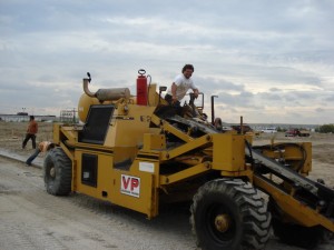 A VP-branded motor grader levelling granular base